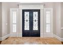 Elegant front entrance with intricate wrought iron double doors and sidelight windows at 621 Champions Dr, Mcdonough, GA 30253
