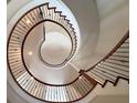 Stunning spiral staircase with wood treads and iron railing, creating an elegant focal point at 621 Champions Dr, Mcdonough, GA 30253