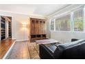 Inviting living room with decorative wooden armoire, large window, and hardwood floors at 2920 Appling Dr, Atlanta, GA 30341