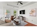 Bright living room with hardwood floors, white walls, a ceiling fan and lots of seating at 821 Ralph Mcgill Ne Blvd # 2412, Atlanta, GA 30306