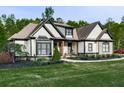 Well-kept single Gathering home displaying stone and black trim accents with a manicured lawn at 1076 Pinyan Ln, Canton, GA 30115