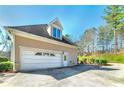 Attached two-car garage with white door and well-maintained exterior, offering convenient access at 2009 Pine Forest Ct, Jonesboro, GA 30236