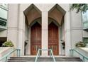 Grand entrance featuring stately concrete arches with rich wood doors leading inside at 2870 Pharr Court S Nw # 1608, Atlanta, GA 30305