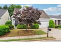 Charming one-story home boasts mature landscaping, two-car garage, and inviting curb appeal at 3911 Delfaire Trce, Cumming, GA 30040