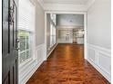 Inviting foyer with hardwood floors and view into living spaces at 3911 Delfaire Trce, Cumming, GA 30040
