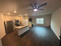 Spacious living room and kitchen area with hardwood floors and a granite-topped island at 6905 Rogers Pt, Lithonia, GA 30058