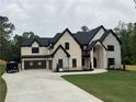 Beautiful two-story home featuring a brick and stone facade, a black roof, and a spacious front lawn at 2728 Talley Ln, Buford, GA 30519