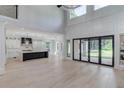 Bright, open-concept living space with hardwood floors and access to kitchen and outdoor space at 2728 Talley Ln, Buford, GA 30519