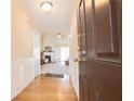 Inviting home entryway with hardwood floors, neutral walls, and a glimpse into the bright, open living area at 7105 Boulder Pass, Union City, GA 30291