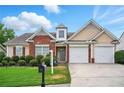 Inviting single-Gathering home with brick accents, manicured landscaping, and a two-car garage on a sunny day at 7105 Boulder Pass, Union City, GA 30291
