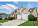 Attractive home featuring brick and tan siding, a well-maintained lawn, and a convenient two-car garage at 7105 Boulder Pass, Union City, GA 30291