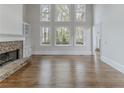 Spacious living room with a stone fireplace and large windows offering natural light at 1209 Fenmore Hall Dr, Powder Springs, GA 30127