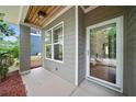 Inviting covered porch with modern siding and a stylish glass front door entrance providing curb appeal at 1765 Stoney Creek Se Dr, Atlanta, GA 30316