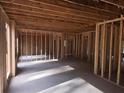 Unfinished interior framing and concrete floor displaying the spacious layout of the home with natural light at 190 Harville Rd, Covington, GA 30016