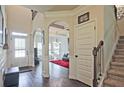 Grand foyer featuring hardwood floors, arched doorways, and a staircase leading to the upper level at 3877 Valley Bluff Ln, Snellville, GA 30039