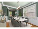 This dining room offers a modern aesthetic with a marble table, stylish decor, and natural lighting at 5106 Davis Love Dr, Cumming, GA 30041