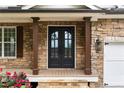 Inviting entryway showcasing double front doors, stone facade and covered porch at 5106 Davis Love Dr, Cumming, GA 30041