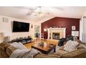 Cozy living room with fireplace, vaulted ceilings, and hardwood floors at 140 Laney Ct, Mcdonough, GA 30252