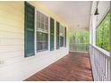 Inviting covered front porch with wooden floors and white railing at 140 Laney Ct, Mcdonough, GA 30252