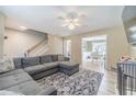 Spacious living room featuring a comfortable gray sectional sofa and bright natural light at 1542 Armende Cir, Dacula, GA 30019