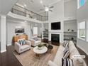 Bright living room with soaring ceilings, fireplace, and large windows at 2470 Bridle Bridge Trl, Cumming, GA 30040