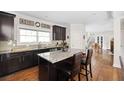 Modern kitchen with granite countertops, dark cabinetry, and a central island at 2634 Charlesgate Ave, Decatur, GA 30030