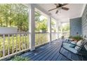 Relaxing covered porch with dark-stained floors and seating area at 2634 Charlesgate Ave, Decatur, GA 30030