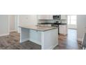 Kitchen island with granite countertops and stainless sink at 267 Eason Ave, Bowdon, GA 30108