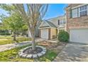 Street-side view of an inviting townhome with a single-car garage and landscaped front yard at 384 Parc River Blvd, Lawrenceville, GA 30046