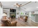 Inviting living room featuring a stone fireplace, vaulted ceiling, and modern decor at 655 Poplar Rd, Dallas, GA 30157