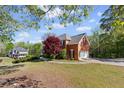 Spacious brick home with an attached garage and well-maintained yard, showcasing a serene neighborhood setting at 4631 Crooked Creek Ln, Villa Rica, GA 30180