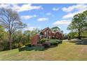 Beautiful exterior showcasing the home's architecture and lush, green surroundings at 4631 Crooked Creek Ln, Villa Rica, GA 30180