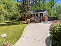 A well-maintained home with a brick facade, front porch, a long driveway, and a lush green lawn at 1211 Argonne Ne Way, Atlanta, GA 30324