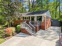 Beautiful home with brick accents, a front porch, and a spacious driveway leading to the entrance at 1211 Argonne Ne Way, Atlanta, GA 30324