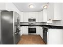 Well-lit kitchen with stainless steel appliances and sleek dark countertops at 1211 Argonne Ne Way, Atlanta, GA 30324
