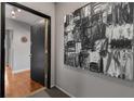 Modern entryway with hardwood floors, gray walls, and striking black-and-white abstract art at 1705 Monroe Ne Dr # D01, Atlanta, GA 30324