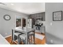 Modern eat-in kitchen with stainless steel appliances, gray cabinetry, and a breakfast bar at 1705 Monroe Ne Dr # D01, Atlanta, GA 30324