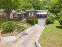 Beautifully maintained brick residence with a well-kept lawn and mature landscaping at 1766 Sw Brewer Sw Blvd, Atlanta, GA 30310