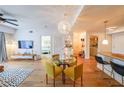 Stylish living room with hardwood floors, a modern chandelier, a dining area, and an open layout to the kitchen at 200 River Vista Dr # 236, Atlanta, GA 30339