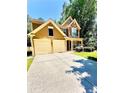 Inviting two-story home featuring a spacious driveway and well-maintained landscaping at 365 Friars Head Dr, Suwanee, GA 30024