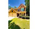 Traditional two-story home with a well-manicured lawn and a two-car garage at 365 Friars Head Dr, Suwanee, GA 30024