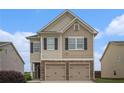 Charming two-story home featuring a two-car garage and neutral siding under a bright blue sky at 4044 Elsdon Dr, Austell, GA 30106