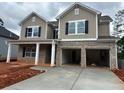 Two-story home with brick and siding, complemented by a two-car garage and inviting front porch at 3536 Dogwood Pass, Stonecrest, GA 30038