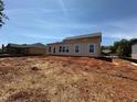Home's rear elevation features several windows for natural light and a door for easy backyard access at 3536 Dogwood Pass, Stonecrest, GA 30038
