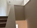 Carpeted stairway with neutral-colored walls, presenting a simple and clean transition between levels at 3536 Dogwood Pass, Stonecrest, GA 30038