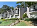 A townhouse exterior with decorative windows, gray and white siding and mature landscaping at 111 Fair Haven Se Way, Smyrna, GA 30080