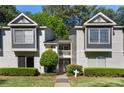 A charming townhome exterior with gray and white siding, decorative windows and manicured landscaping at 111 Fair Haven Se Way, Smyrna, GA 30080