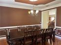 Formal dining room with a large table, ornate chairs, and a chandelier at 220 Fannin Ln, Hampton, GA 30228
