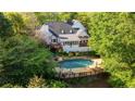 Beautiful backyard featuring a large pool, deck and surrounded by mature trees at 4820 Coppedge Trl, Peachtree Corners, GA 30096