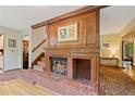 Cozy fireplace with brick surround and decorative mantle and wood trim at 4820 Coppedge Trl, Peachtree Corners, GA 30096